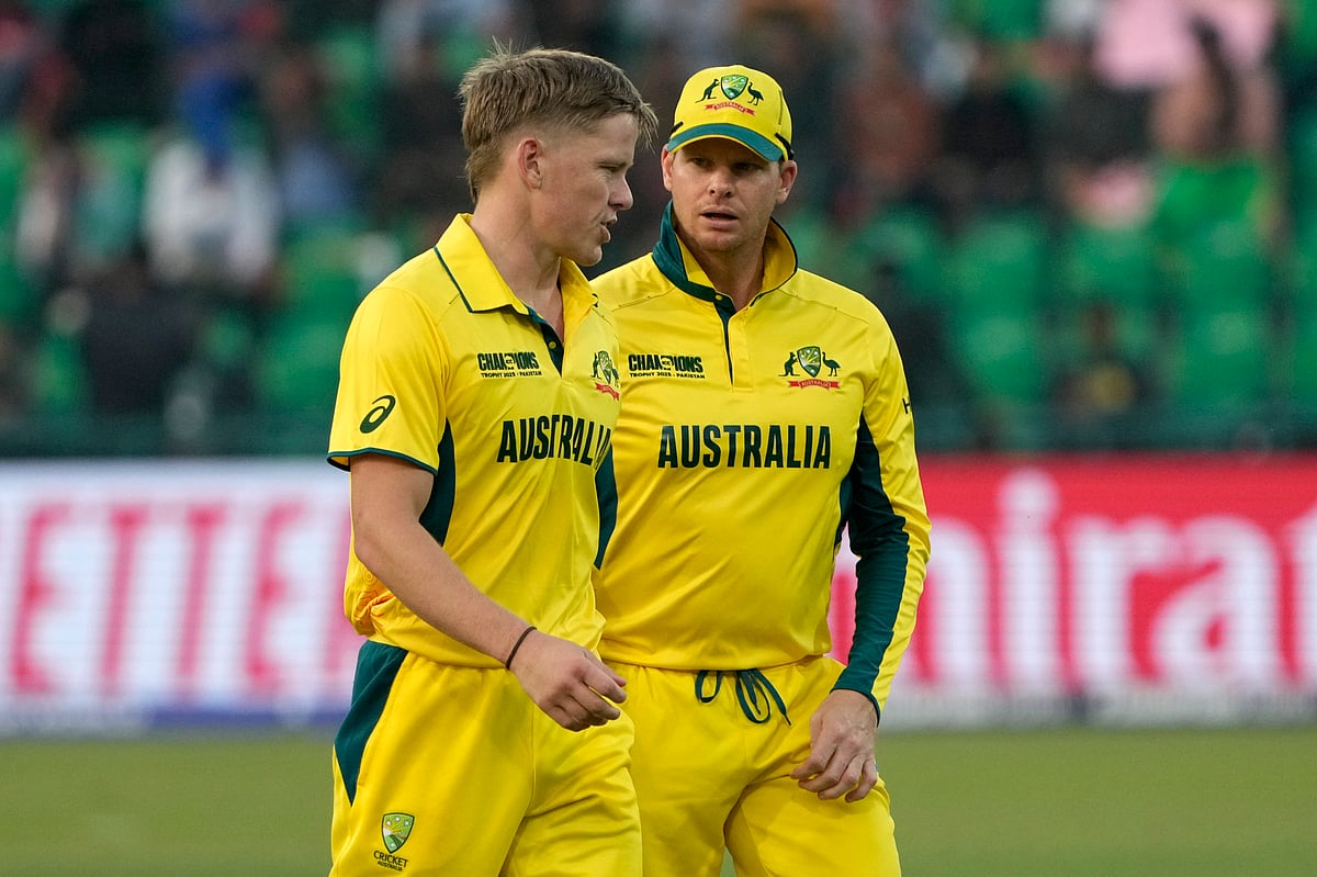  (AP Photo/K.M. Chaudary) : Australia's Nathan Ellis, left, chats with Steve Smith during the ICC Champions Trophy cricket match between Australia and Afghanistan, in Lahore, Pakistan, Friday, Feb. 28, 2025.