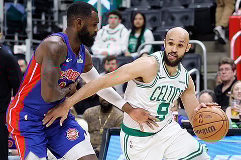 NBA 2024-25: Celtics guard Derrick White (9) drives against Pistons forward Tim Hardaway Jr.