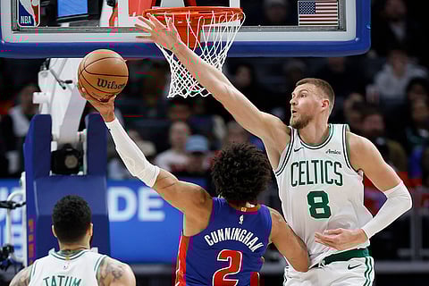 NBA 2024-25: Celtics center Kristaps Porzingis (8) defends against a shot