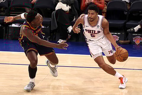 NBA 2024-25: 76ers' Quentin Grimes, right, dribbles the ball
