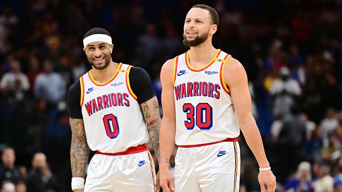 Stephen Curry #30 and Gary Payton II #0 of the Golden State Warriors react in the second half against the Orlando Magic at Kia Center on February 27, 2025 in Orlando, Florida. - null