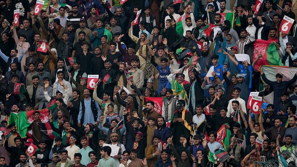 AP : Fans cheer for their team during the ICC Champions Trophy match between Australia and Afghanistan in Lahore.