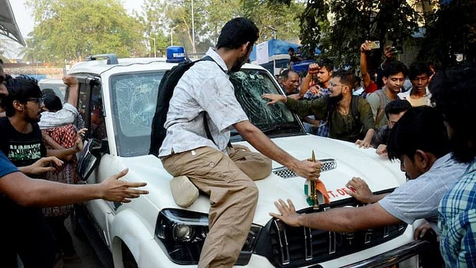 PTI : SFI members 'gheraoed' West Bengal Education Minister Bratya Basu's car inside JU on Saturday.