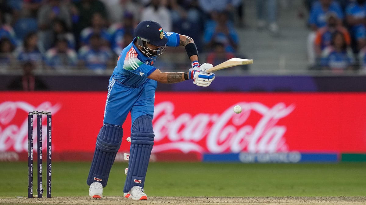 AP Photo/Altaf Qadri : India's Virat Kohli plays a shot during the ICC Champions Trophy cricket match between India and Pakistan at Dubai International Cricket Stadium.