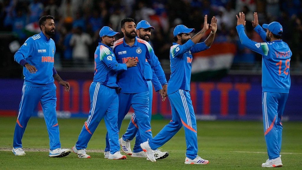 AP : India's Varun Chakravarthy, third from right, celebrates the wicket of New Zealand's Matt Henry with teammates during the ICC Champions Trophy.