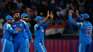 AP Photo/Altaf Qadri : India's Varun Chakravarthy celebrates the wicket of New Zealand's Matt Henry with his team mates during the ICC Champions Trophy cricket match between India and New Zealand at Dubai International Cricket Stadium in Dubai.