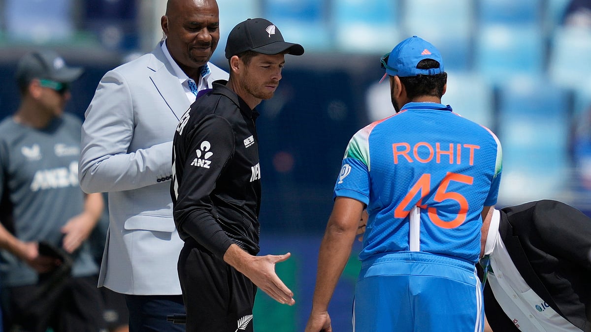 Altaf Qadri/AP : New Zealand's captain Mitch Santner, center, greets India's captain Rohit Sharma after the coin toss ahead of the ICC Champions Trophy cricket match between India and New Zealand at Dubai International Cricket Stadium in Dubai