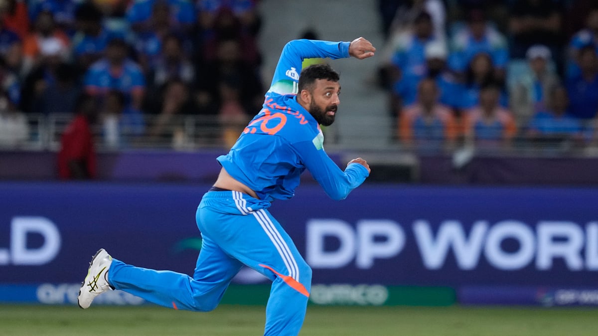 AP Photo/Altaf Qadri : India's Varun Chakravarthy bowls a delivery during the ICC Champions Trophy cricket match between India and New Zealand at Dubai International Cricket Stadium in Dubai.