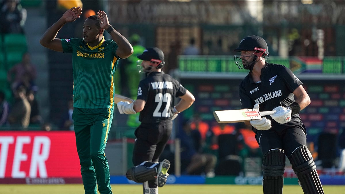 AP Photo/K.M Chaudary : South Africa's Kagiso Rabada, left, reacts after a shot played by New Zealand's Kane Williamson, center, during the ICC Champions Trophy semifinal cricket match between New Zealand and South Africa at Gaddafi Stadium in Lahore.