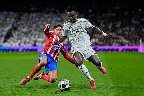 UCL 2024-25 Round Of 16 First leg, RMA vs ATM: Giuliano Simeone, left, fights for the ball with Vinicius Junior