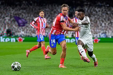 UCL 2024-25 Round Of 16 First leg, RMA vs ATM: Marcos Llorente, left, fights for the ball with Vinicius Junior