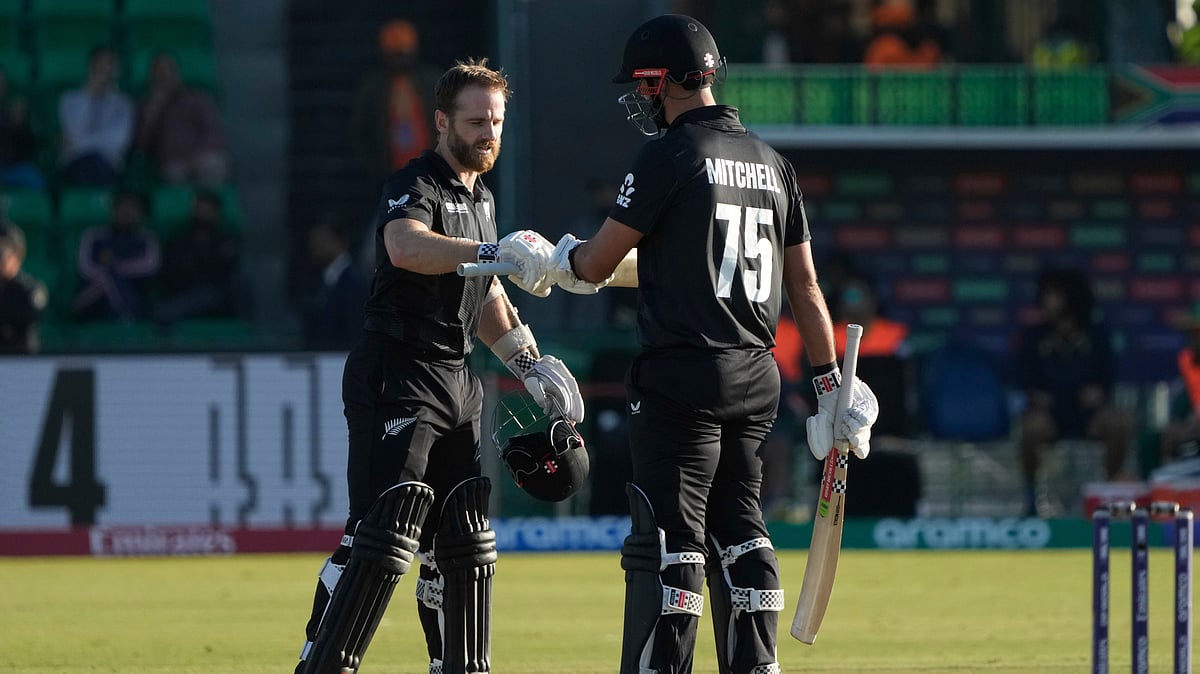 AP Photo/K.M Chaudary : New Zealand's Kane Williamson, left, celebrates with batting partner Daryl Mitchell after scoring a century during the ICC Champions Trophy semifinal cricket match between New Zealand and South Africa at Gaddafi Stadium in Lahore.