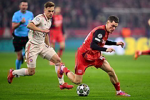 UCL round of 16 first leg, FCB vs Bayer 04: Leverkusen's Florian Wirtz and Munich's Joshua Kimmich challenge for the ball