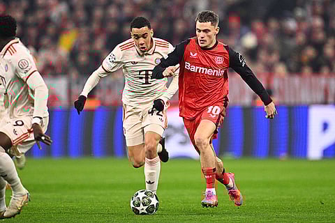 UCL round of 16 first leg, FCB vs Bayer 04: Leverkusen's Florian Wirtz and Munich's Jamal Musiala challenge for the ball