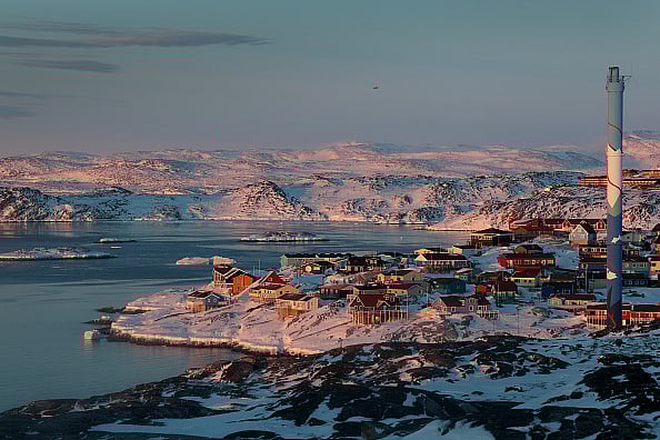 The village of Ilulissat, with a population of approximately 4000, sits among glaciers and snow-covered hills on March 03, 2025.