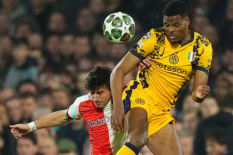 UCL round of 16 first leg, FEY vs Inter: Inter Milan's Denzel Dumfries and Feyenoord's Hugo Bueno jump for the ball
