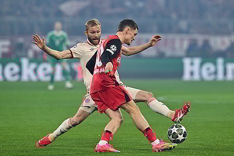 UCL round of 16 first leg, FCB vs Bayer 04: Leverkusen's Florian Wirtz and Munich's Konrad Laimer challenge for the ball