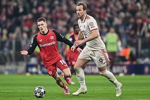 UCL round of 16 first leg, FCB vs Bayer 04: Leverkusen's Florian Wirtz and Munich's Harry Kane challenge for the ball