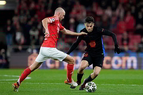 UCL round of 16 first leg, SLB vs FCB: Barcelona's Pedri is challenged by Benfica's Fredrik Aursnes