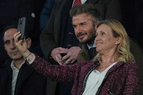UCL round of 16 first leg, PSG vs LFC: Former England soccer player David Beckham poses for a photo with a spectator