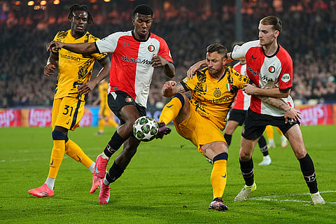 UCL round of 16 first leg, FEY vs Inter: Inter Milan's Marko Arnautovic in action between Feyenoord's Jeyland Mitchell and Thomas Beelen