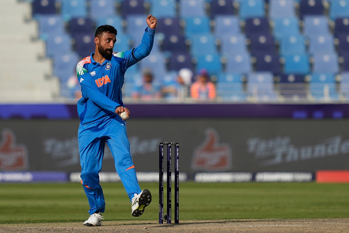 (AP Photo/Altaf Qadri) : India's Varun Chakravarthy bowls a delivery during the ICC Champions Trophy semifinal cricket match between India and Australia at Dubai International Cricket Stadium in Dubai, United Arab Emirates, Tuesday, March 4, 2025. 