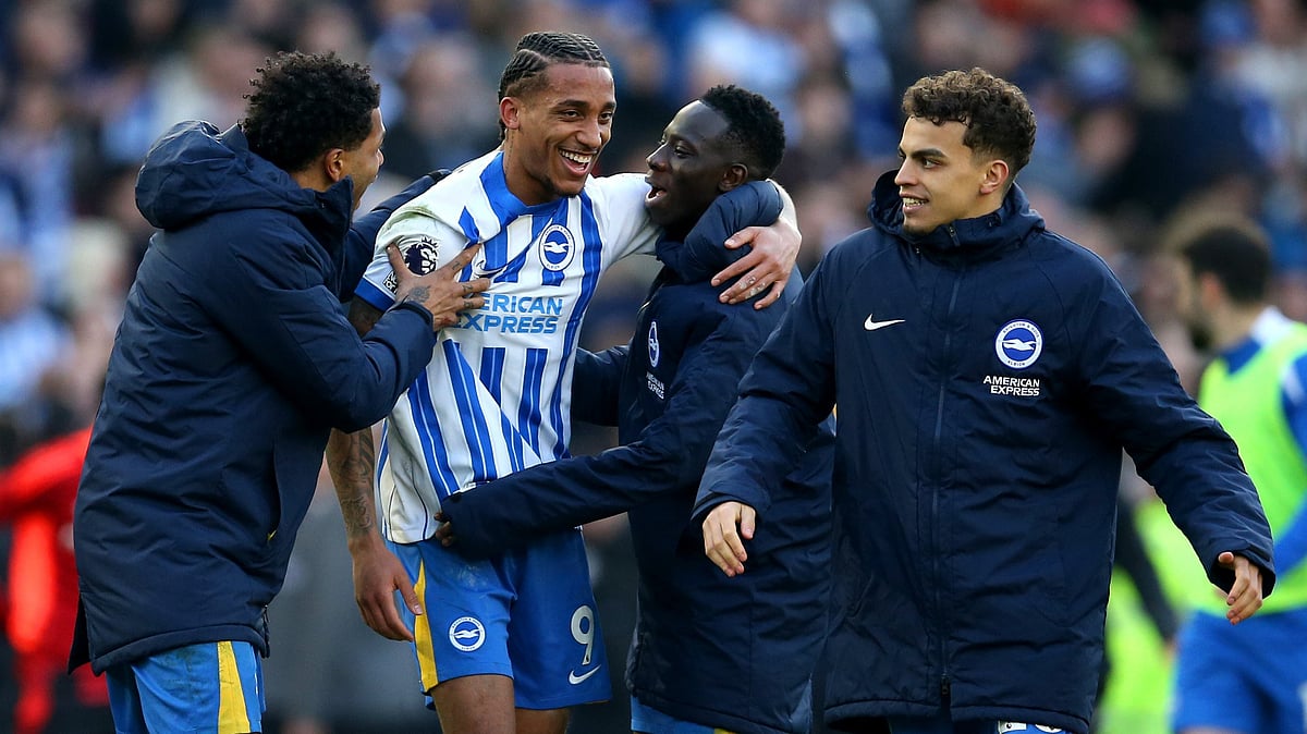 Joao Pedro is mobbed by his team-mates after Brighton's win over Fulham