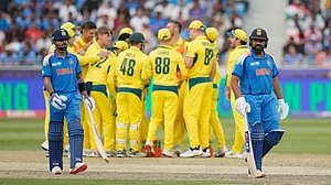 AP : Rohit Sharma, right, walks off after losing his wicket as Virat Kohli, left, watches during the ICC Champions Trophy semi-final between India and Australia.