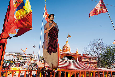 Standing Tall: A larger than life cutout of Bageshwar Baba at the entrance of Bageshwar Dham temple