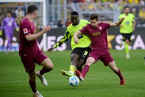 Bundesliga, Borussia Dortmund vs FC Augsburg: Dortmund's Serhou Guirassy and Augsburg's Elvis Rexhbecaj in action