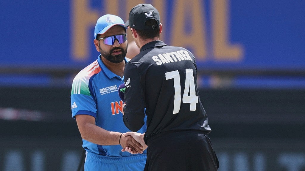 AP/Christopher Pike : India's captain Rohit Sharma, left, shakes hands with New Zealand's captain Mitchel Santner after the toss prior to the start of the ICC Champions Trophy final.