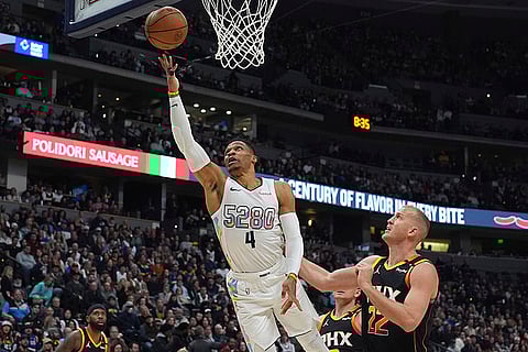 NBA 2024-25: Denver Nuggets guard Russell Westbrook, left, drives to the basket