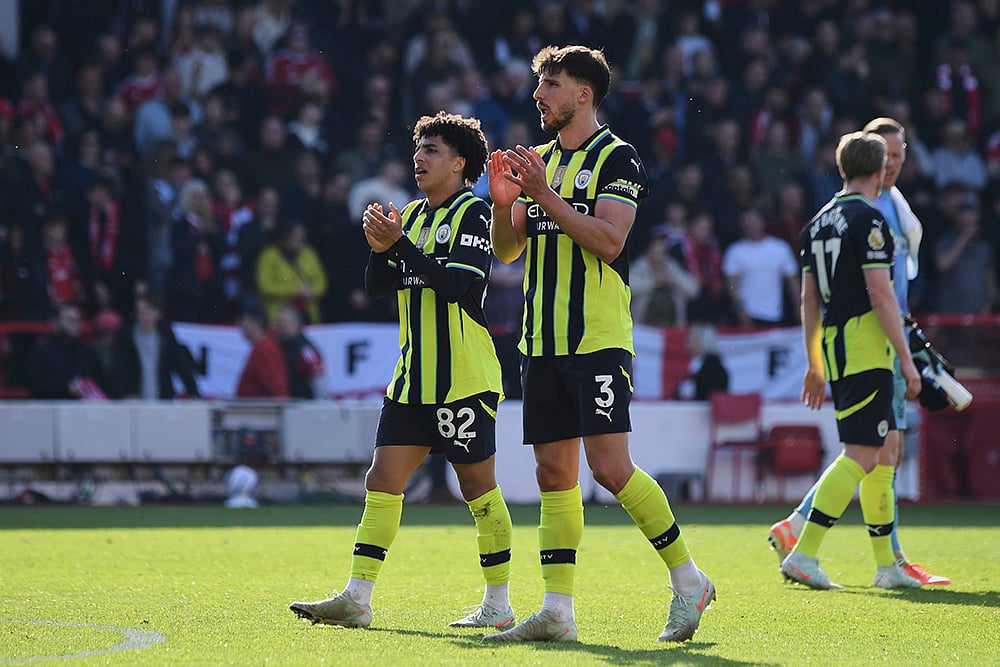 | Photo: AP/Rui Vieira : EPL 2024-25, Forest Vs Man City: Manchester City's Rico Lewis, left, and Ruben Dias greet fans
