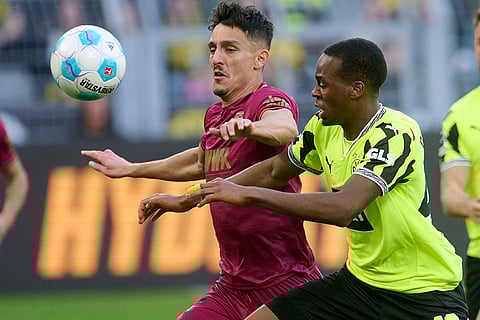 Bundesliga, Borussia Dortmund vs FC Augsburg: Dortmund's Jamie Gittens and Augsburg's Dimitris Giannoulis in action