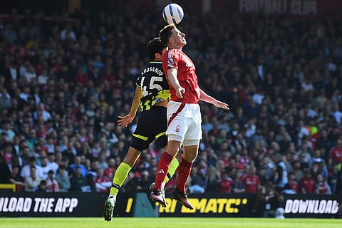 EPL 2024-25, Forest Vs Man City: Nottingham Forest's Chris Wood, front, and Manchester City's Abdukodir Khusanov compete for the ball