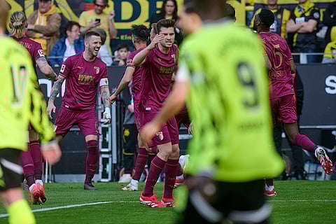 Bundesliga, Borussia Dortmund vs FC Augsburg: Augsburg's Jeffrey Gouweleeuw, left, celebrates after scoring a goal