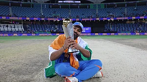 AP/Christopher Pike : India's captain Rohit Sharma poses with the winners trophy after defeating New Zealand in the final cricket match of the ICC Champions Trophy at Dubai International Cricket Stadium in Dubai, United Arab Emirates, Sunday, March 9, 2025.