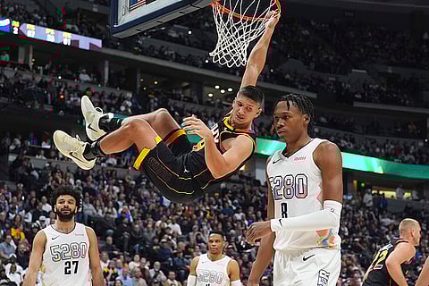 NBA 2024-25: Phoenix Suns guard Grayson Allen, center, hangs from the rim