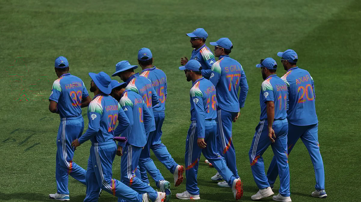 AP Photo/Christopher Pike : Indian players walk into the field during the ICC Champions Trophy final cricket match between India and New Zealand at Dubai International Cricket Stadium in Dubai.