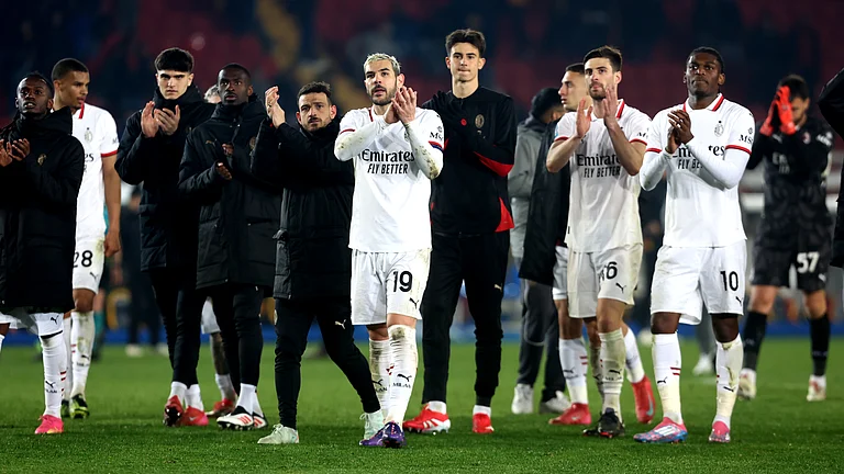 Milan's players celebrate after their victory against Lecce - null