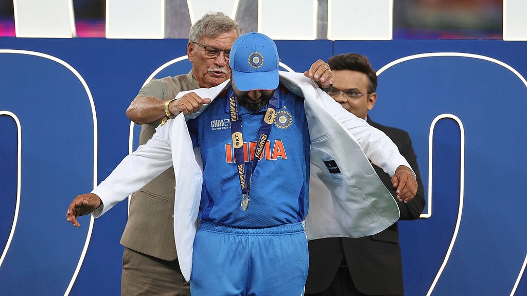 AP/Christopher Pike : India's captain Rohit Sharma receives the white coat from BCCI President Roger Binny during the presentation ceremony of the ICC Champions Trophy after their win against New Zealand at Dubai International Cricket Stadium in Dubai, United Arab Emirates, Sunday, March 9, 2025. 
