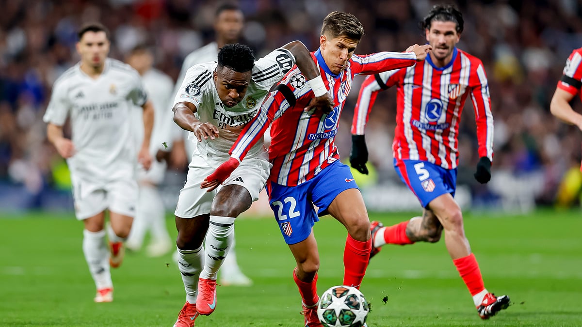 Vinicius Junior of Real Madrid and Giuliano Simeone of Atletico Madrid battle for possession in the first leg - null