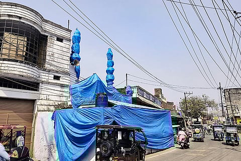 Mosque covered ahead of Holi procession