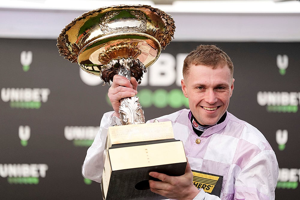 | Photo: Adam Davy/PA via AP : Cheltenham Festival, Day 1: Lorcan Williams celebrates winning the Unibet Champion Hurdle Challenge Trophy