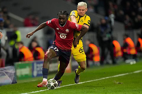 UCL 2024-25, Lille vs Dortmund: Lille's Ngal'ayel Mukau and Dortmund's Julian Ryerson fight for the ball 