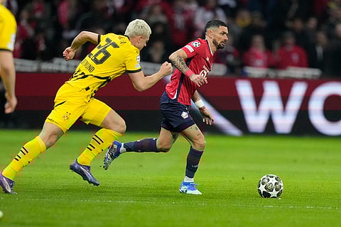 UCL 2024-25, Lille vs Dortmund: Dortmund's Julian Ryerson and Lille's Remy Cabella fight for the ball 
