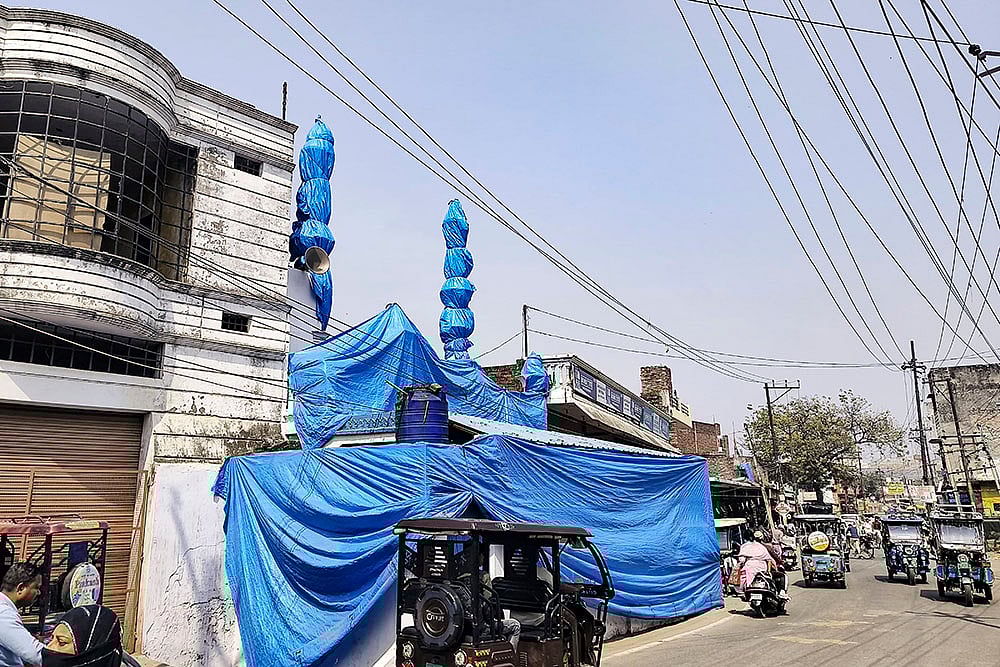 | Photo: PTI : A mosque covered in tarpaulin