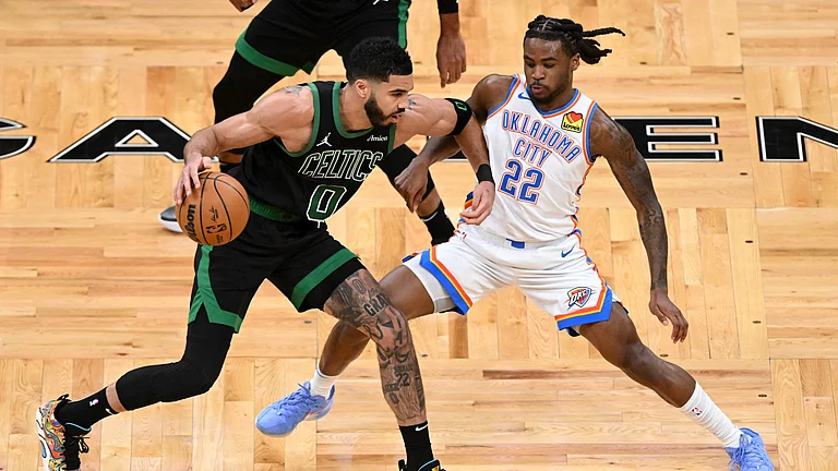 ayson Tatum #0 of the Boston Celtics dribbles the ball to the basket against Cason Wallace #22 of the Oklahoma City Thunder during the second quarter at the TD Garden on March 12, 2025 in Boston, Massachusetts. - null