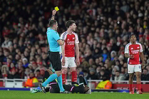 UCL 2024-25, Arsenal vs PSV: Referee Rade Obrenovic shows a yellow card to Arsenal's Declan Rice