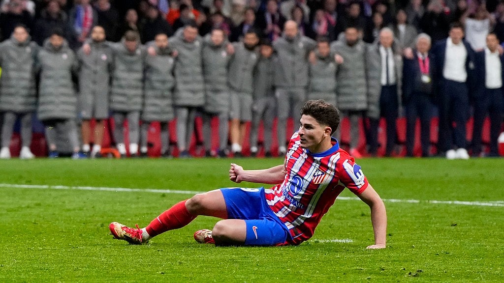 AP/Manu Fernandez : Atletico Madrid's Julian Alvarez falls to the ground after taking a penalty kick during a shootout at the end of the Champions League round of 16, second leg.